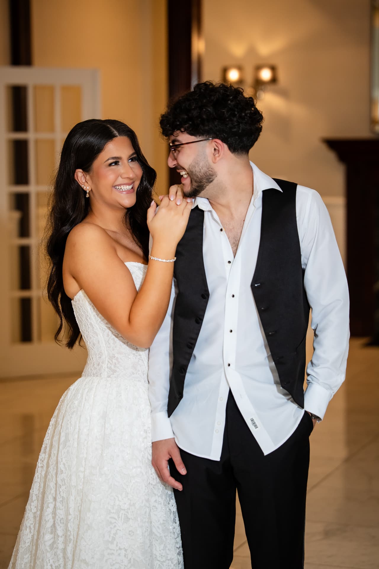 Bride and groom sharing a smile at their reception